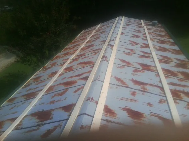 Rusted metal roof panels with new wood purlins before replacement — Storm Damage Roof Repair in Cascade by Roofing Brothers
